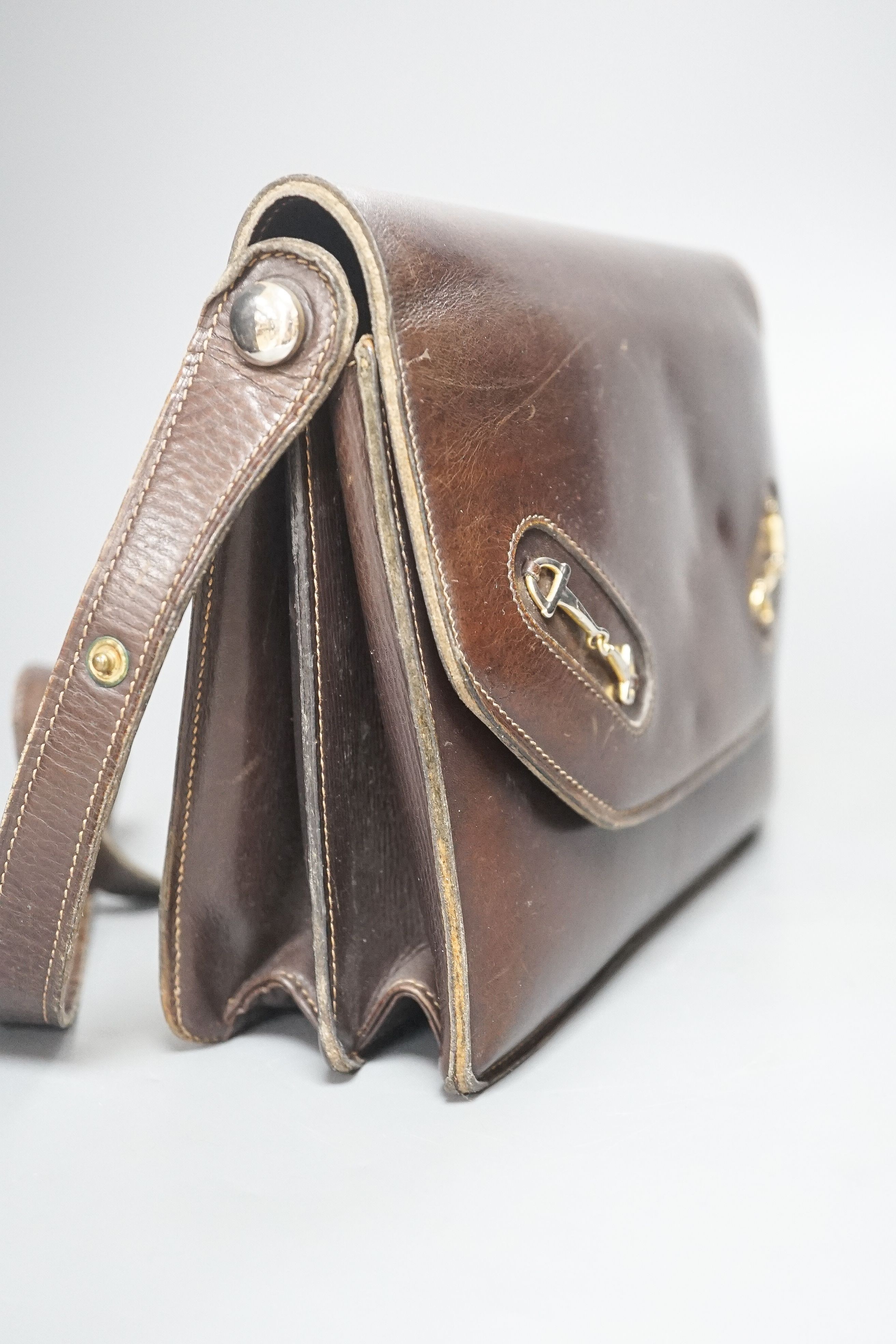 A vintage brown leather handbag stamped 